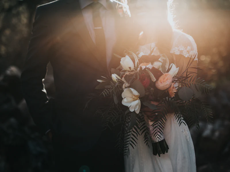 Couple in wedding attire with a bouquet